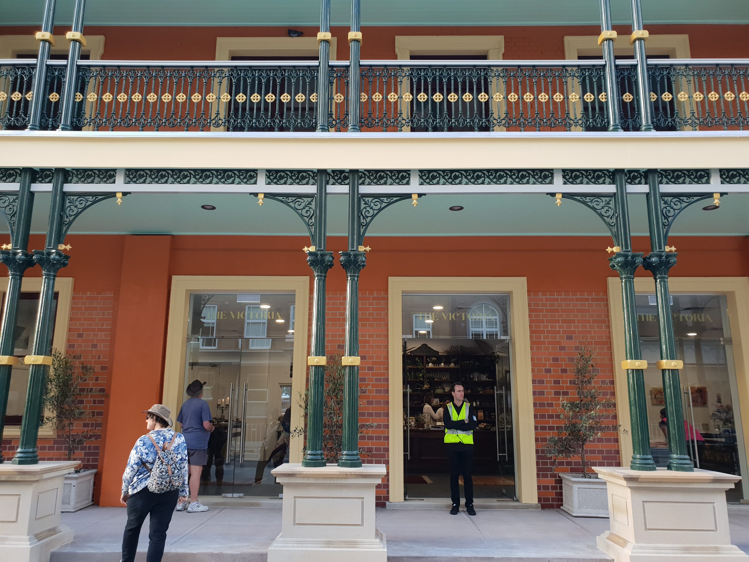 Picture shows the side of The Station Newcastle, a man in high vis can be seen standing at the door with his arms crossed.