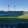 Picture shows blue clear skys and the Sydney SCG stadium, seats are empty and the venue is not being used, the grass is well manicured and green.