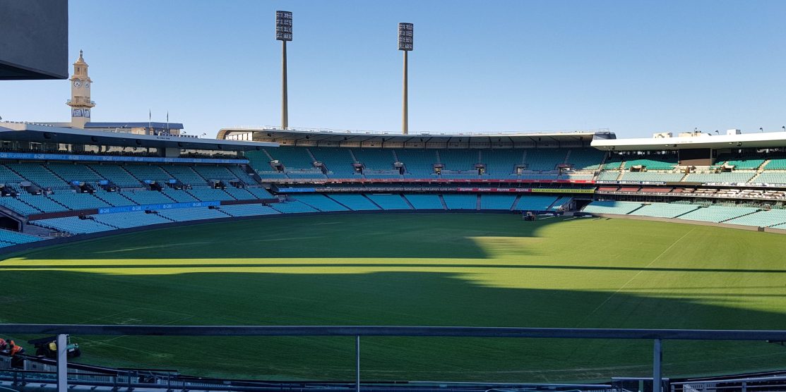 Picture shows blue clear skys and the Sydney SCG stadium, seats are empty and the venue is not being used, the grass is well manicured and green.