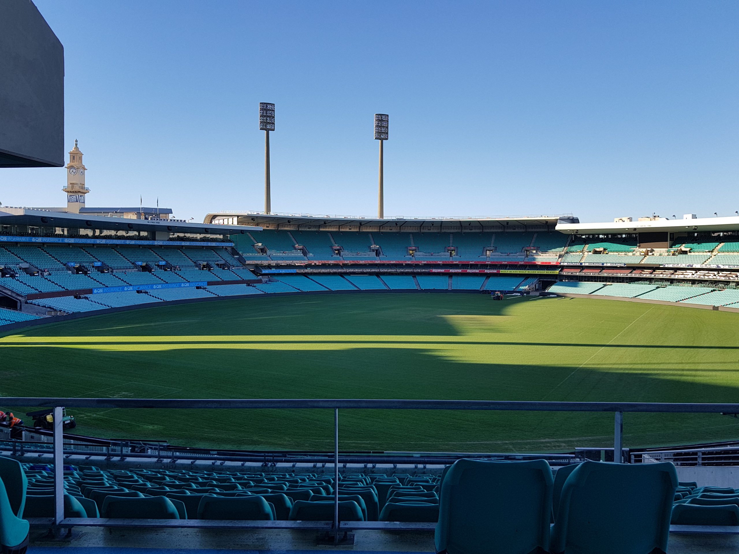 Picture shows blue clear skys and the Sydney SCG stadium, seats are empty and the venue is not being used, the grass is well manicured and green.