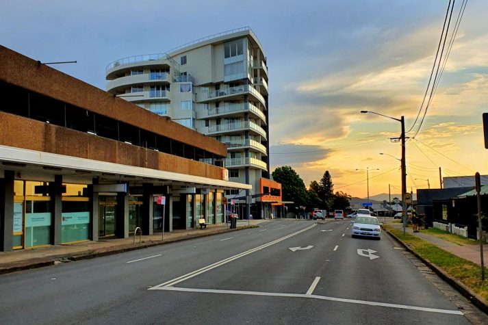 Image shows Alto apartments at Charlestown NSW, and Charlestown Road, a car can be seen in the left lane pulling up to the pedestrian crossing between Hilltop Plaza and Service NSW building. also near Matara Hotel.