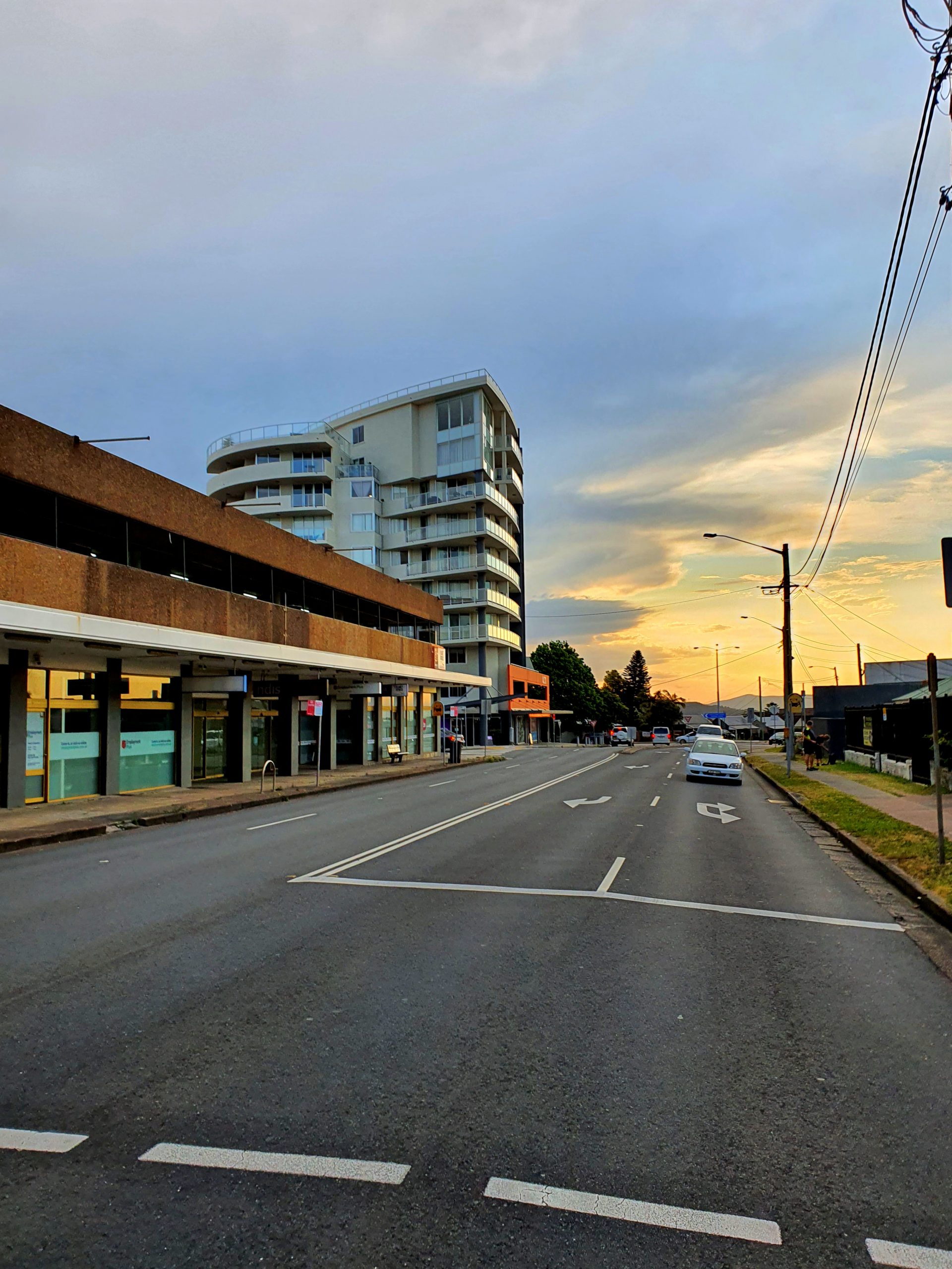 Image shows Alto apartments at Charlestown NSW, and Charlestown Road, a car can be seen in the left lane pulling up to the pedestrian crossing between Hilltop Plaza and Service NSW building. also near Matara Hotel.